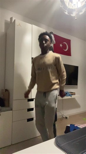 Energetic Dance Practice in a Casual Bedroom Setting