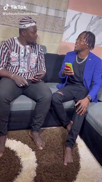 Counting Cash on the Couch: A Fun Duo Moment