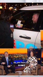 FOX 5's Jennifer Delgado attempts to deliver donuts to a police officer while visiting the D.C. Holiday Market in DuPont Circle. | Fox 5 DC