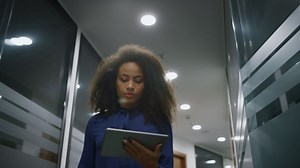 African american business woman walking in a office corridor | Free Stock Video Footage