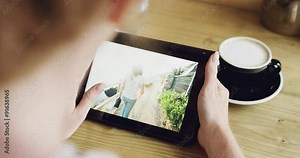 Beautiful young woman using ipad tablet touch screen in cafe