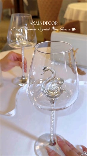 7.7K views · 46 reactions | The Swan’s Promise Crystal Wine Glass Set whispers of love and elegance, hand-blown from the finest crystal that catches the light like starlight upon water. With swans poised in eternal grace, each glass turns a simple toast into poetry—an intimate symbol of devotion, beauty, and rare refinement meant only for those who treasure life’s most exquisite moments. | Anaïs Candle | Facebook