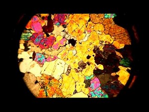A thin section viewed through a petrographic microscope with stage rotation
