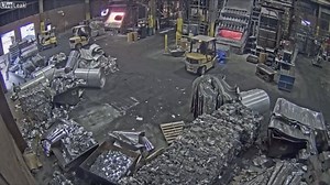 Foundry worker puts wet scrap metal in furnace, November 27, 2019