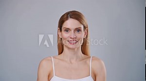 Close up portrait of woman that is standing in the studio and smiling.