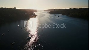 Aerial view Sunrise Rowing Team in Halifax Ocean Bay, Canada. Drone footage shows a sports canoe team rowing in unison in the peaceful waters of Halifax's ocean bay at sunrise.