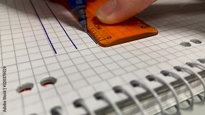 Draw lines with a ruler on a piece of paper in a notepad