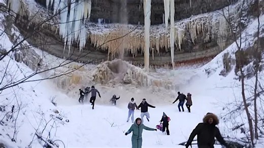 Frozen waterfall collapses as huge icicles crash down near families