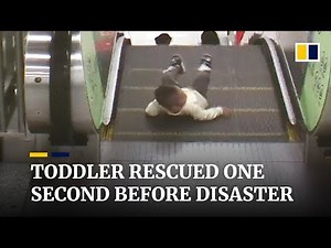 Toddler rescued from escalator one second before disaster
