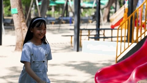 clip-4048349055-two-young-girls-smile-interact-near-red