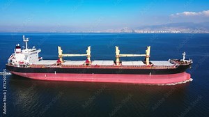Bulk carrier or bulker is a merchant ship transport unpackaged bulk cargo, grains, ore, coal. Aerial wide shot