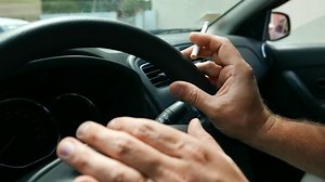 clip-29376958-smoking-tobacco-cigarettes-while-driving-nicotine-addiction