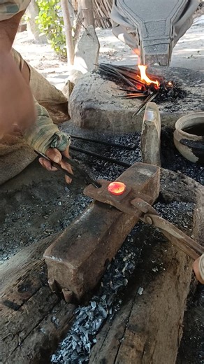 Watch how a skilled blacksmith hand-forges nails from old iron by hammering it into shape."