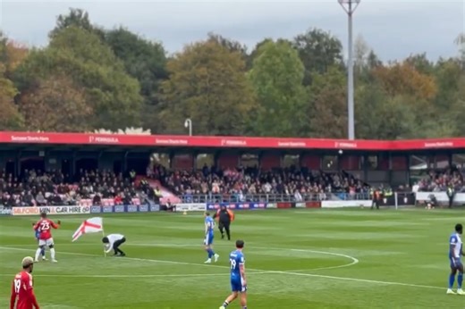 Salford game disrupted by pitch invaders with England flags in protest to Gary Neville