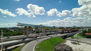 Expansive Bridge Construction Over Dolphin Expressway, Miami. Launching Gantry segmental bridge construction setup.