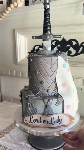 Lord of the Rings inspired Baby Gender Reveal Cake!! The dagger coming out of the cake with the gender color is everything! This cake is fantastic and majestic and royal and epic and masterful!! Yes! And….a little lady is on her way!!! 🌸🗡️ Loved making this one! The text from my client..”Have gotten SO MANY compliments. It was perfect and delicious. Thank you! ” Order your dream cakes with Flour Stone! Online at flourstoneaz.com #lordoftherings #epiccake #genderrevealcake #flourstonebakery #ca