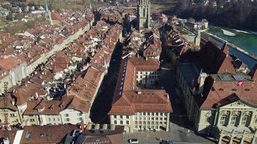 Bern, Switzerland: Aerial drone footage of Bern old town with medieval buildings and the cathedral in Switzerland capital city. Shot with a tilt up motion