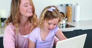 clip-5933285-portrait-caucasian-mother-daughter-using-laptop-together