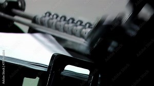 An Old Letterpress Printing Press Machine Printing Sheets of Braille Paper. Close up. 4K Resolution.