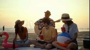 Enjoy moment of friends group party dancing and play music on the beach and cheers alcohol drinks on summer sunset. Group people having fun enjoy beach party drinking beer. Summer vacation concept.