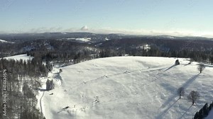 Aerial footage of the harz after a heavy snow storm in the winter of 2021. The Harz is a german national Park in with beautiful mountain landscapes in central Germany, Europe.