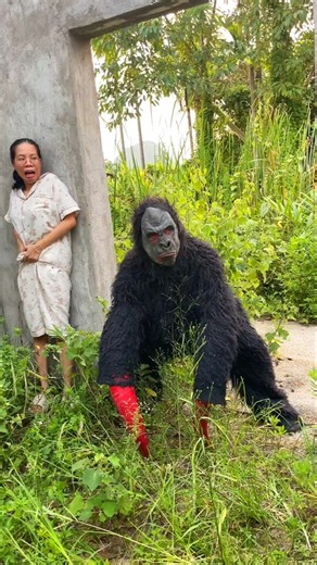 Ferocious Gorilla-Like Monster Attacks A Brave Beautiful Girl Hiding Behind A Wall