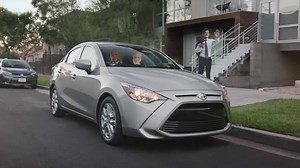 Stock photo cutouts driving a Scion iA may seem weird, but there’s nothing weird about standard features like 16-inch alloy wheels or push-button start. ￼ | Local Toyota Dealers