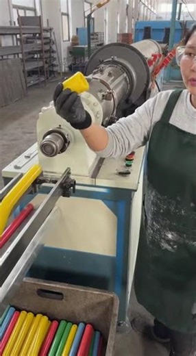 Woman Using Machine to Manufacture Plastic Broom Handles