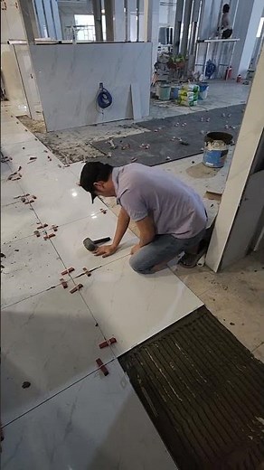 Laying floor tiles over existing tiles, using two types of tiles, large and small. #construction