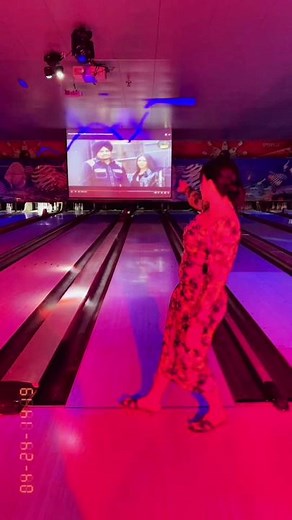 Bowling in Style: Floral Dress and Winged Tattoo