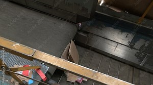 Conveyors carry trash and empty platforms at recycling plant. Processing of municipal solid waste into an energy source. Utilization waste-to-energy. Trash sorting. Conveyor for waste. Recycling garba