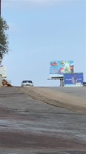 Classic Vintage Car Driving on Sunny Road
