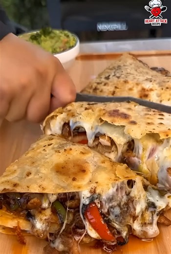Is it even a quesadilla if it's not overflowing with cheesy goodness like this?! ✨ Pure perfection. #QuesadillaGoals #cheesepull #mexicanfood #LunchGoals | Heart Attack Recipe