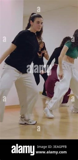 Group of energetic young female dancers rehearsing a synchronized hip hop routine in a modern studio with a mirror, showing skill, passion, and teamwork during an active fitness class Stock Video Footage - Alamy