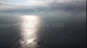 Abstract nature ocean sea background. Small waves on cristal clear water surface in motion blur with bokeh lights from sunrise. Never-ending beauty of nature. Holiday, vacation background concept