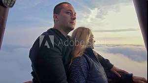 Adventure love couple on hot air balloon watermelon. Man and woman kiss hug love each other. Burner directing flame into envelope. Happy people.