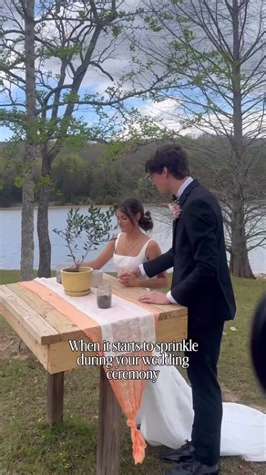 Just as the vows were sealed by the lake, the skies opened up. 🌧️ What started as a sprinkle quickly turned into a full downpour, leaving the entire wedding party soaked.But instead of running for cover like the planner suggested, the bride had a better idea.Hand in hand, the newlyweds took off sprinting toward the dock and leaped straight off the edge into the lake! 💦Gasps, cheers, and pure shock filled the air as everyone watched the most spontaneous, joyful moment unfold. The groom swept hi