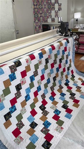 Finishing the Falling Charms Quilt. Pieced by my friend Linda. I did an all over loopy meander.