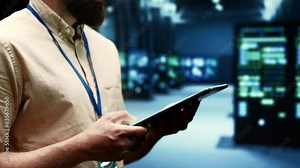 Computer scientist doing maintenance on VPN servers with high security standards used to adequately protect sensitive data. Data center providing secure internet connections for users