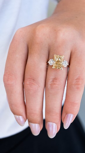 Fancy Yellow diamond Lovers… this custom engagement ring is for YOU! 💛 This stunning 3ct Intense Yellow Radiant Lab-Grown diamond is paired with two complementary Round diamond side stones to create a gorgeous Three Stone engagement ring. What do you think? #brdiamonds #customengagementring #yellowdiamond | Buchroeders Jewelers