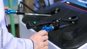 The surgeon performs an operation in virtual reality. New technologies in surgery. Surgeon operating medical robotic surgery machine. Manual control by Minimally Invasive Surgical System