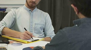 Download Handsome businessman taking notes during business meeting for free