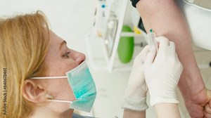 Close-up of a female doctor setting up a blood sampling system. A vertical shot in which the doctor performs her work professionally. High quality 4k footage