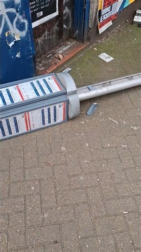 Bus Stop sign fell down on the floor in UK London