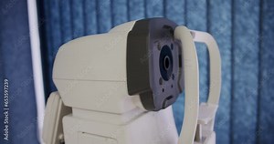 Modern refractometer at ophthalmologist cabinet in hospital. Ophthalmology diagnostic equipment for eye test. Ophthalmic professional apparatus for examination eyesight.