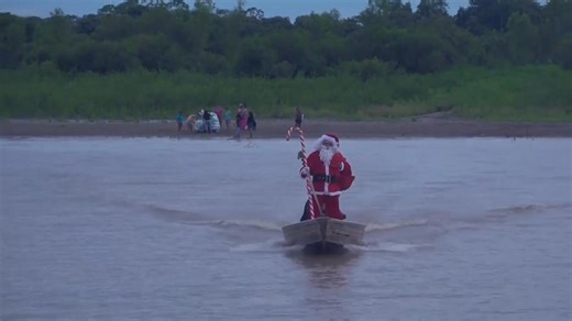 Santa Claus navigates through Brazil's Amazon delivering gifts and Christmas joy