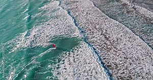 air view windsurfing in the sea. Active rest on the ocean, swimming on the waves on a board with a sail. High quality 4k footage