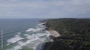 Foamy Waves Rushing Onto Sandy Beaches Of Broken Head Nature Reserve In Northern Rivers, New South Wales, Australia. Aerial Drone Shot