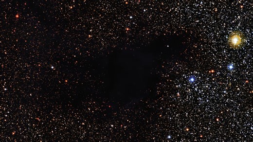 Close-up: Dark Nebula LDN 483 in Serpens (The Serpent) | MPG/ESO Telescope FriendsofNASA.org: Where did all the stars go? This dark cloud obscures hundreds of background stars. The Wide Field Imager (WFI) on the MPG/ESO 2.2-meter telescope at the La Silla Observatory in Chile snapped this image of the dark nebula LDN 483. The object is a region of space clogged with gas and dust. These materials are dense enough to effectively eclipse the light of background stars. LDN 483 is located about 700 l