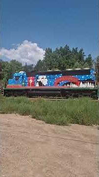 Diesel locomotive hauling huge excursion train through Royal Gorge near Canon City, Colorado